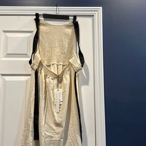 Beautiful cream dress new with tags has a black ribbon tie back detail